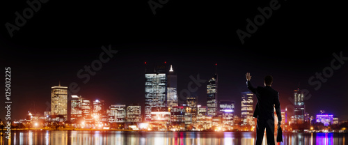 Businessman viewing night glowing city