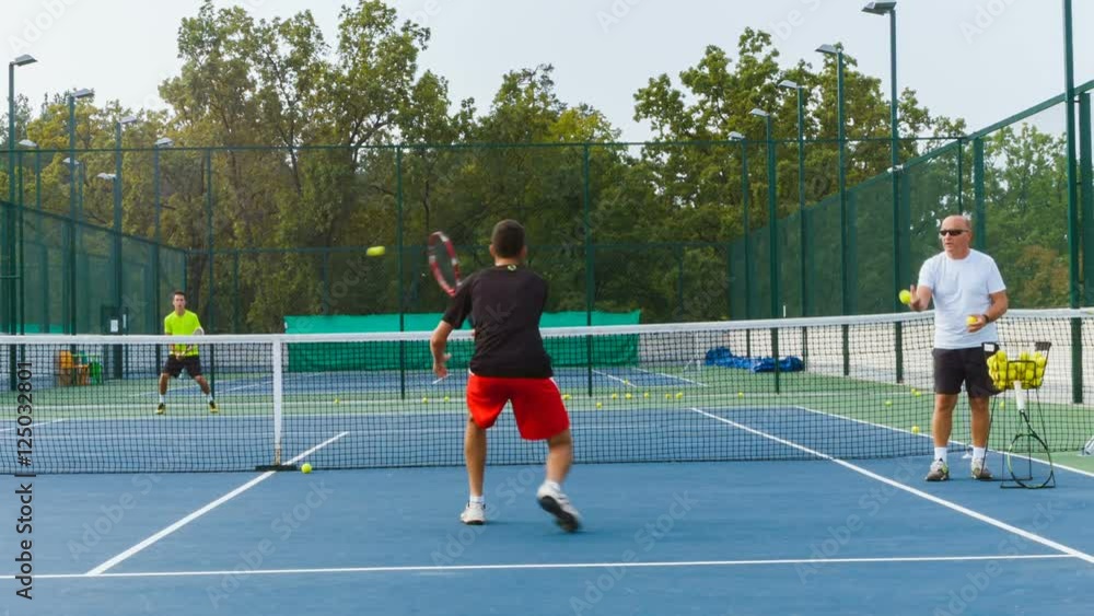 Coaching or teaching play tennis on a court outdoor. Training of professional sports players