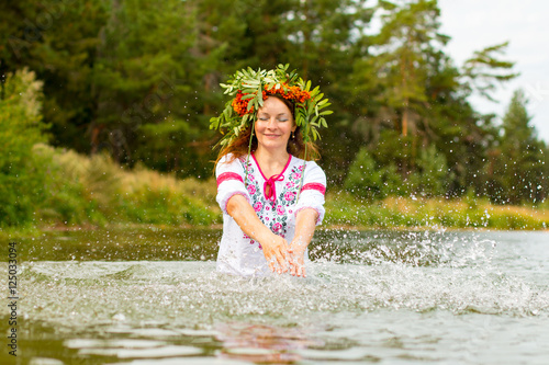 Fototapeta Naklejka Na Ścianę i Meble -  Pretty girl in national dress is in water