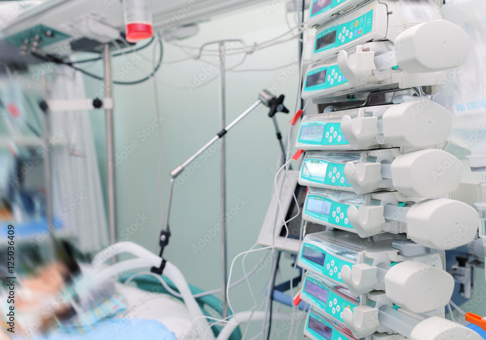 Modern equipped hospital room with patient in bed Modern equipped hospital room with patient in bed