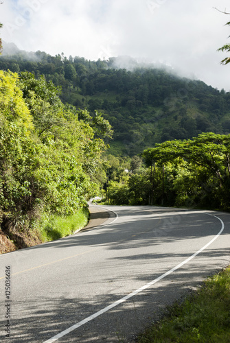 Asphalt road in summer day. Guatemala rain forest