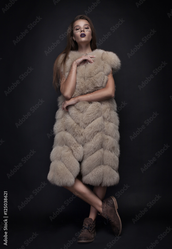 Beauty Fashion Model Girl in Blue Mink Fur Coat. Beautiful Luxury Winter Woman with creative make writing fuck you on face Beauty Fashion Model Girl in Blue Mink Fur Coat. Beautiful Luxury Winter Woman with creative make writing fuck you on face