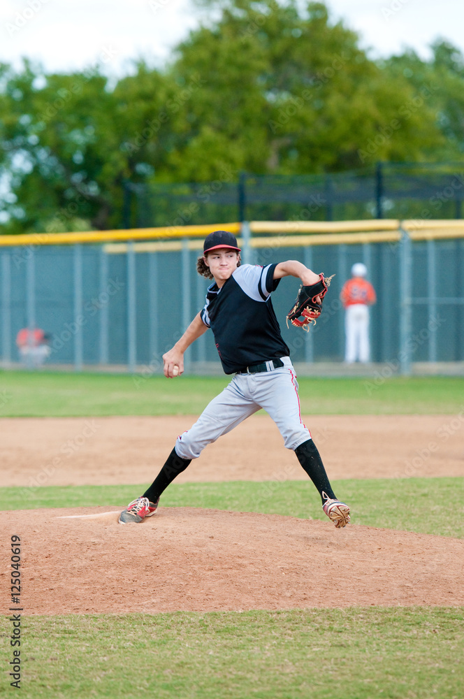 American teen baseball player pitching