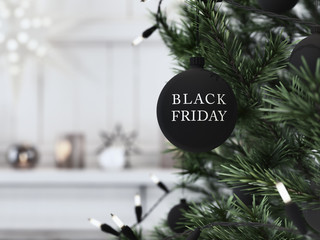 black friday christmas ball hanging on a christmastree. 3d rendering