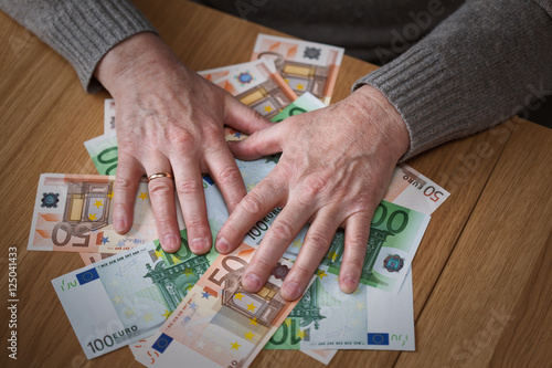 Photos The greedy man closes hands Euro banknotes