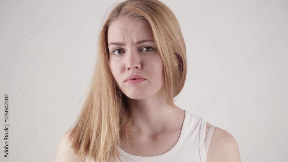 Young woman showing several emotion expressions, isolated on light grey background. No color grading (color corrected version available) Young woman showing several emotion expressions, isolated on light grey background. No color grading (color corrected version available)
