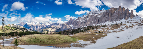 Panorama of snowy Dolomites in spring in sunny day, Italy