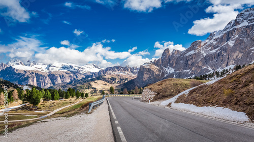 Road leading to snow capped Dolomites, Italy