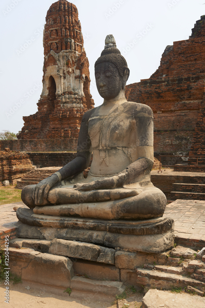 Ancient stone temple on sunny day in Ayuttaya, Thailand.
