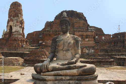 Ancient stone temple on sunny day in Ayuttaya, Thailand.