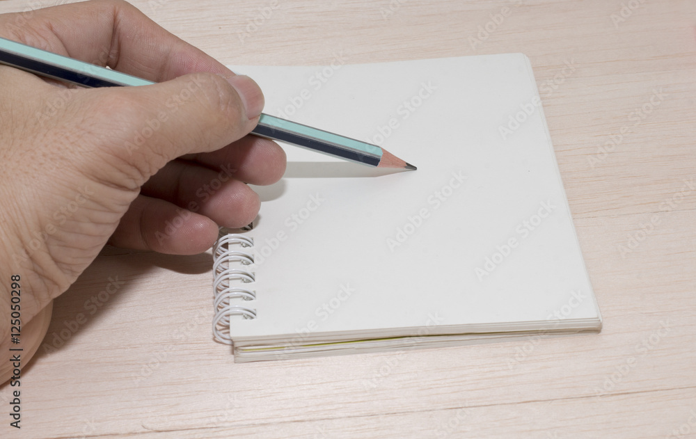 office desk with group of pencil and hand , hand write note on paper,white paper,copy space,blank paper for write note office desk with group of pencil and hand , hand write note on paper,white paper,copy space,blank paper for write note