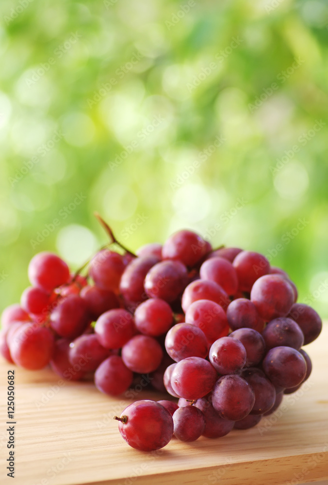 Bunch of red grapes , green background Bunch of red grapes , green background