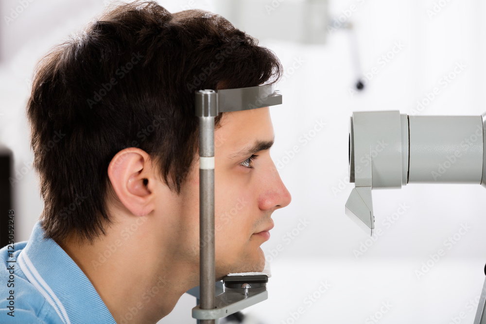 Man Checking Eyesight In Clinic Man Checking Eyesight In Clinic