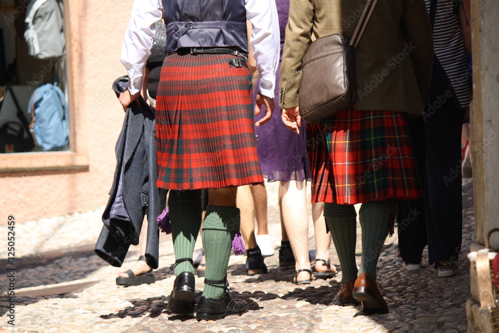 Malcesine. Garda lake. Men wearing kilt, walking in the street Malcesine. Garda lake. Men wearing kilt, walking in the street