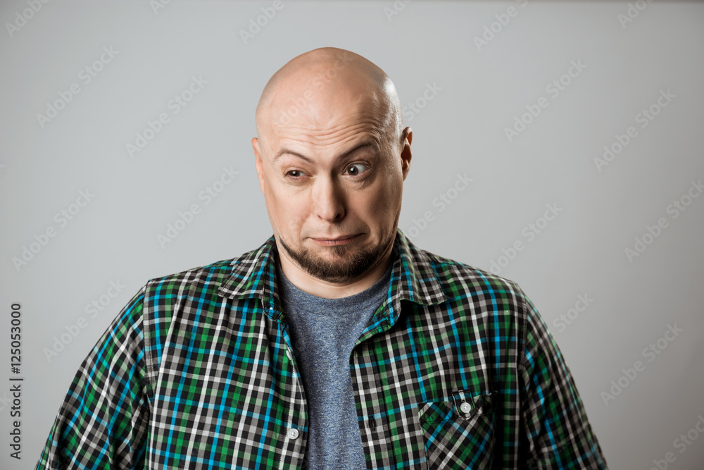 Portrait of displeased young handsome man over beige background. Portrait of displeased young handsome man over beige background.