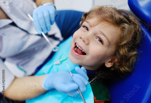 child with curly hair at the dentist