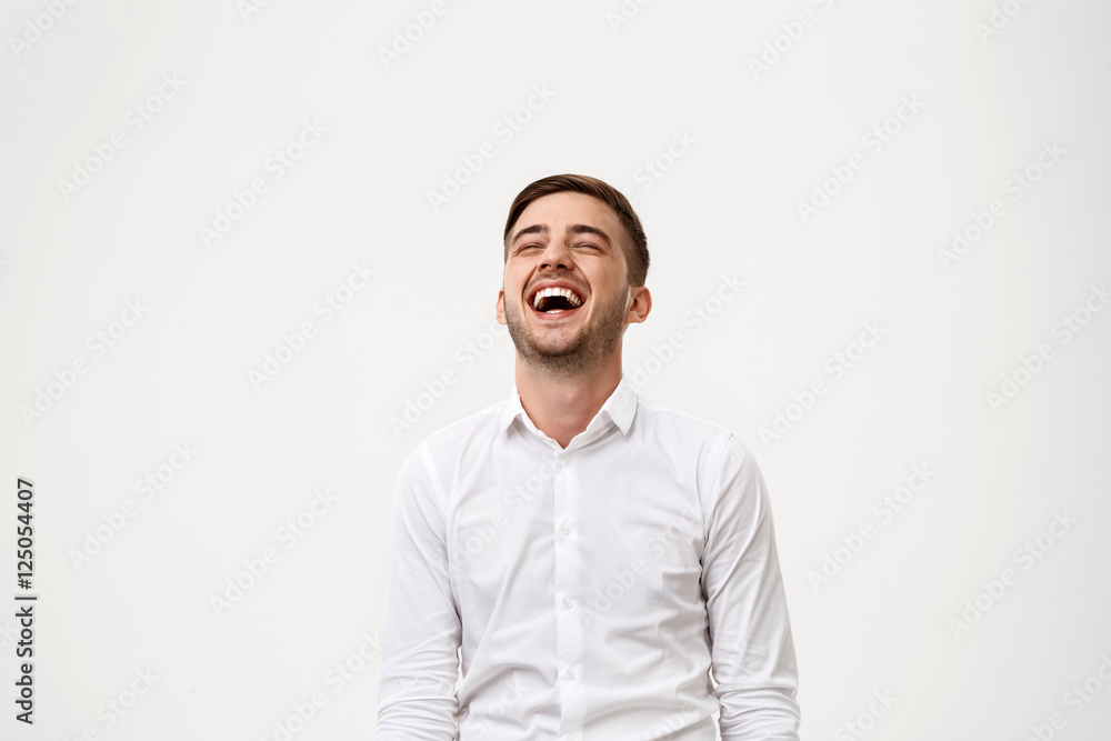 Young successful businessman smiling, laughing over white background. Young successful businessman smiling, laughing over white background.