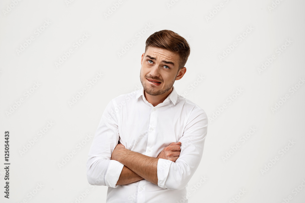 Successful businessman thinking, posing with crossed arms over white background. Successful businessman thinking, posing with crossed arms over white background.