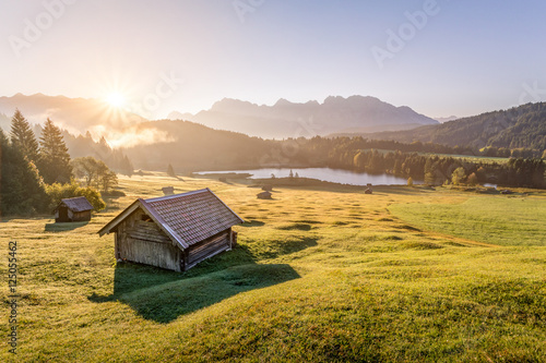View over Geroldsee with wooden hut and Karwendel mountains at morning, Bavaria, Germany photo