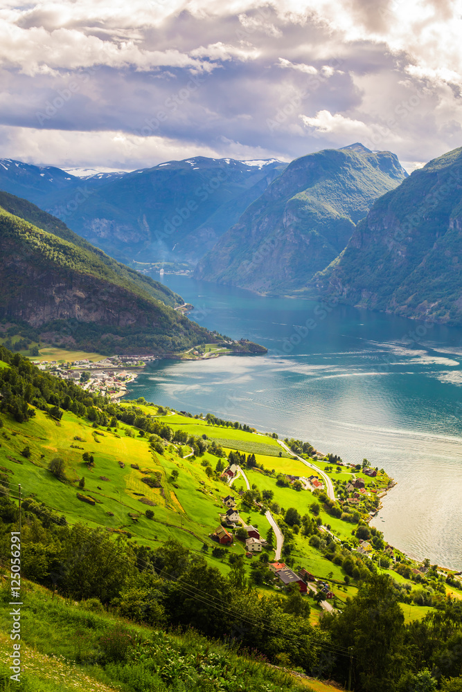 View to Sognefjord in Norway. Small town and cruise port Olden in Norwegian fjords. Bird view of fjord in Norway. under a sunny, blue sky, with the typical rorbu houses. View from the top