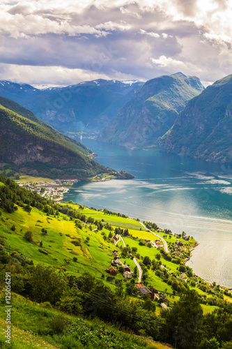View to Sognefjord in Norway. Small town and cruise port Olden in Norwegian fjords.  Bird view of fjord in Norway.  under a sunny  blue sky  with the typical rorbu houses. View from the top