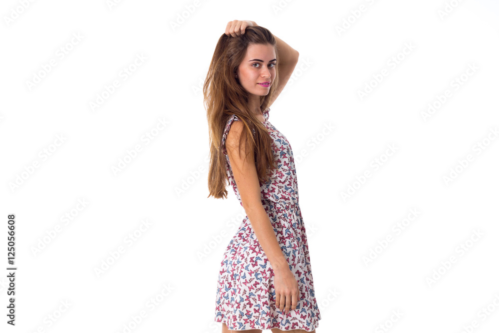 Woman standing sidewise and touching hair Woman standing sidewise and touching hair