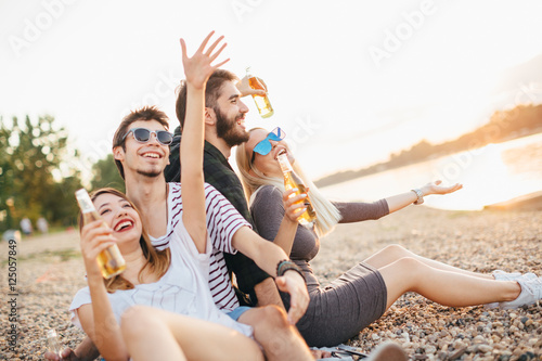 Group of friends having fun by the river 