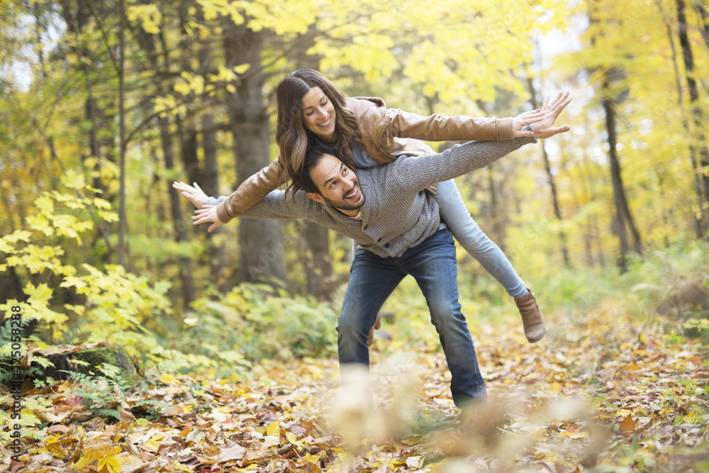 Nice couple having fun in autumn park Nice couple having fun in autumn park