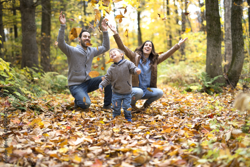 Happy family relaxing outdoors In autumn park Happy family relaxing outdoors In autumn park
