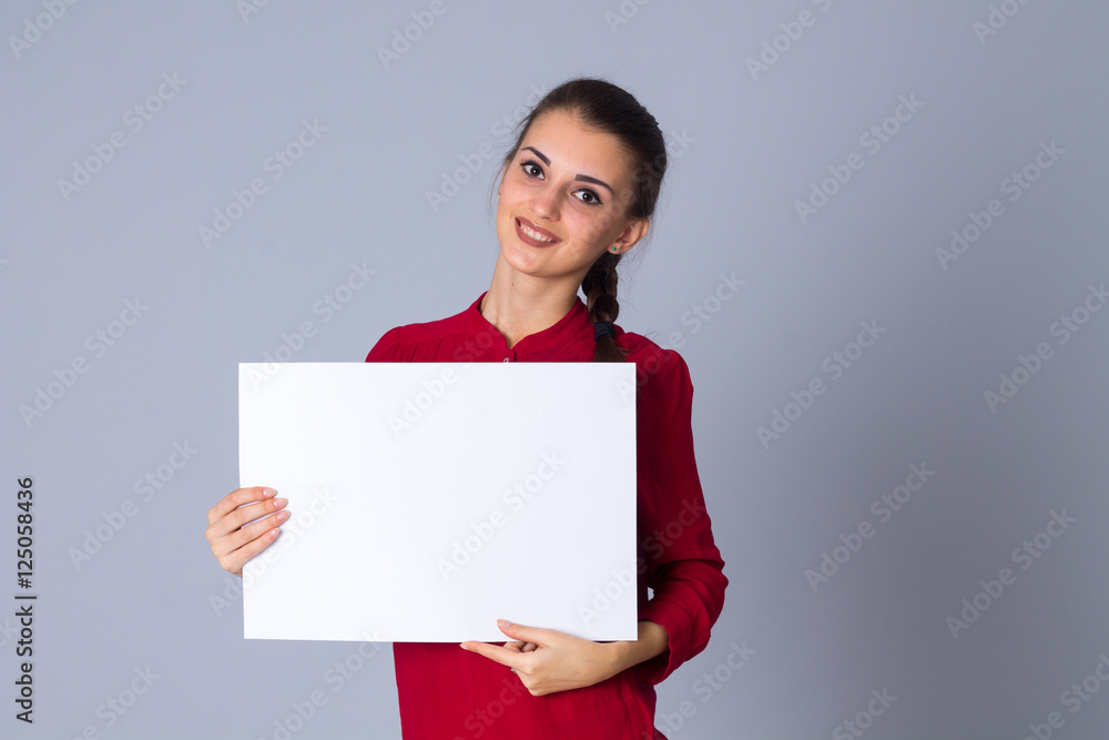 Woman holding white sheet of paper Woman holding white sheet of paper