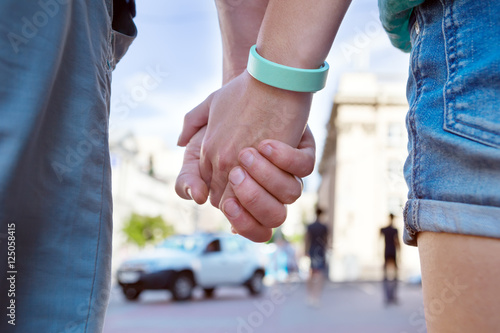 Couple hands closed together outdoors