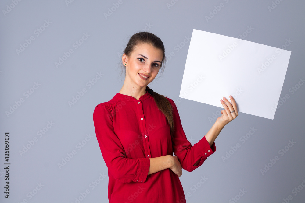 Woman holding white sheet of paper