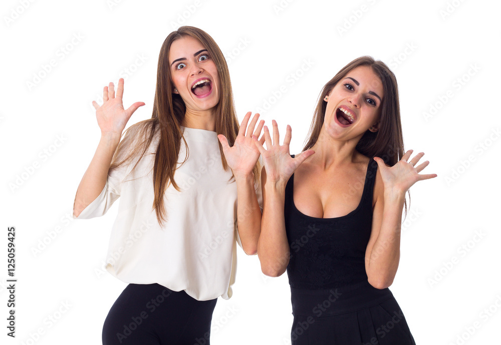 Two young woman holding hands up