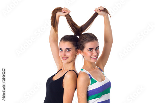 Two young women holding their hair