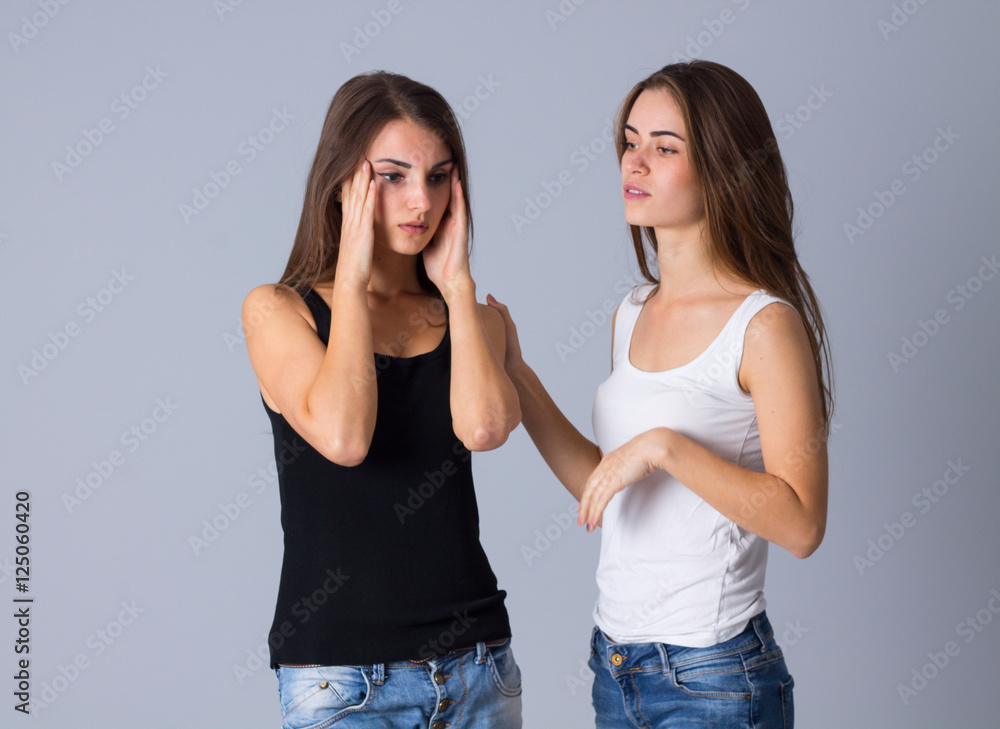 One woman worrying and another calms her down One woman worrying and another calms her down