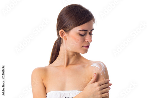 Young woman using cream