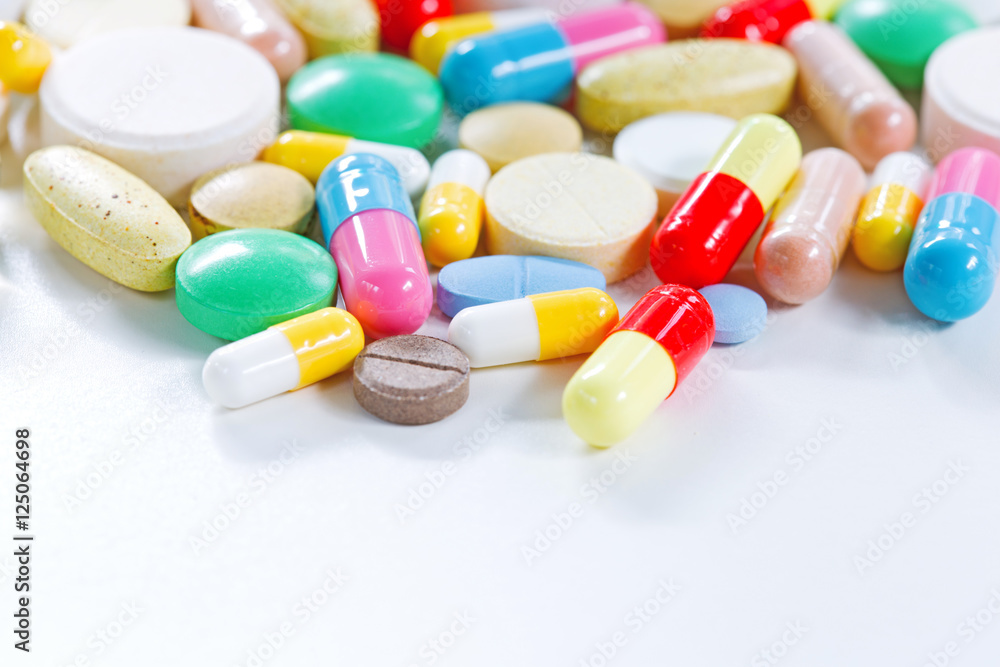 Vitamins, omega 3, cod-liver oil, dietary supplement and tablets an embankment on a light background close up, the top view Vitamins, omega 3, cod-liver oil, dietary supplement and tablets an embankment on a light background close up, the top view