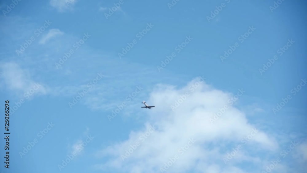 Small sport airplane flying in the background of blue sky, view from below, clear blue sky in background Small sport airplane flying in the background of blue sky, view from below, clear blue sky in background