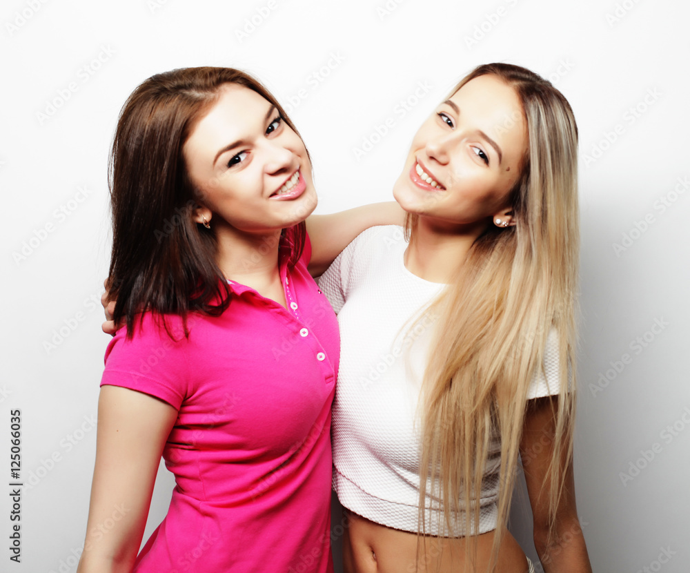 lifestyle and people concept: Two young girl friends standing to lifestyle and people concept: Two young girl friends standing to