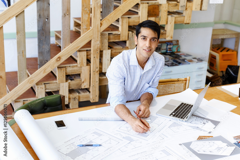 Young man architect in office