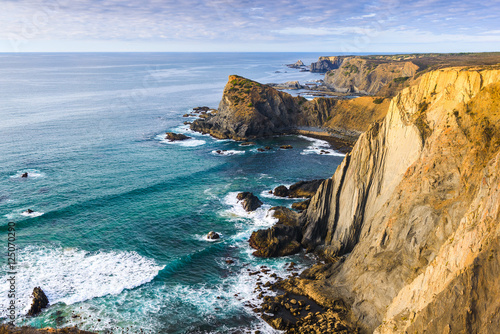 Atlantic ocean rocky coastline near Arrifana. Vicentina Coast Natural Park. Algarve region. Portugal photo