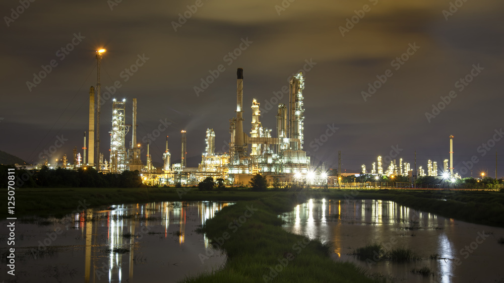 Oil refinery plant at sunrise with sky background