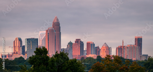 A luminescent and colorful sunrise hitting the buildings that make up the Charlotte, North Carolina skyline. 