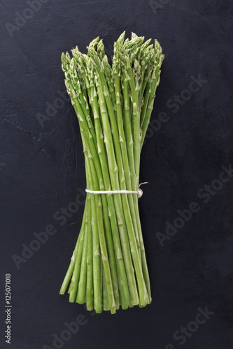 asparagus on wooden table in black