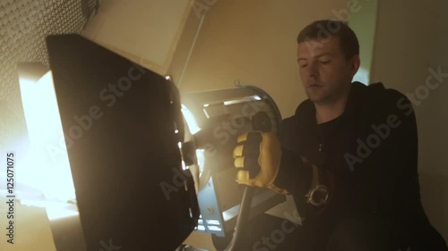lighting technician works with the light on a film set