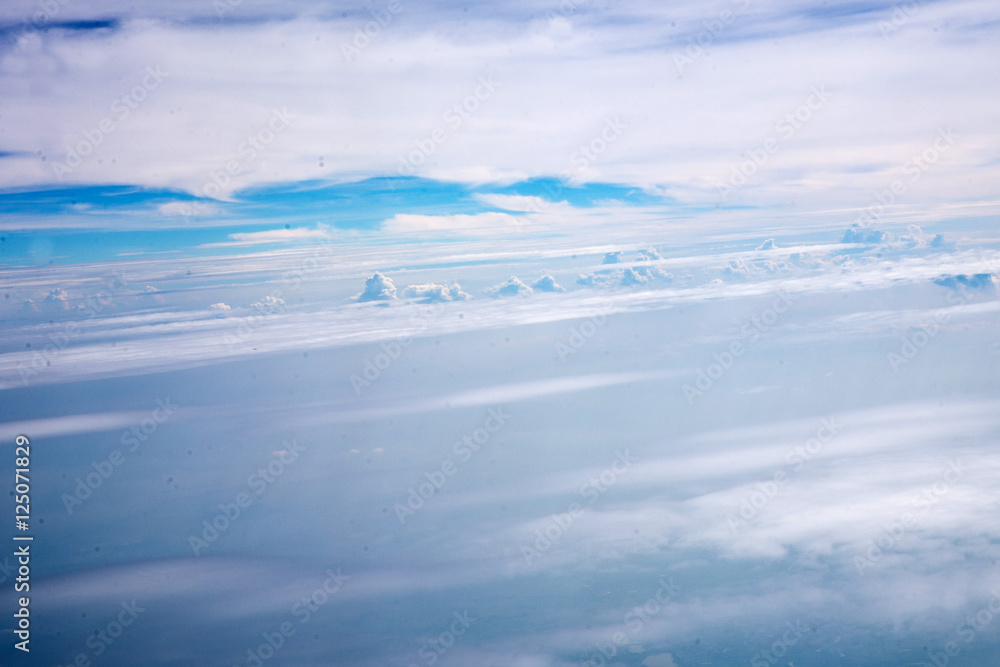 Obraz premium Clouds and sky as seen through window of an aircraft