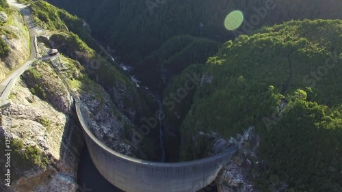 Forward flight towards Gordon Dam passing over it at sunset in Tasmania, Australia