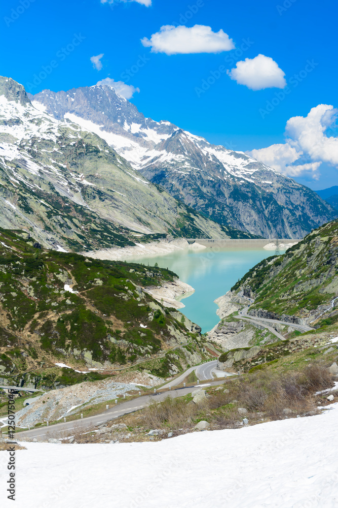 Grimsel Pass. Scenic view from the grimsel pass in Switzerland down to the turqouise lake with the dam.