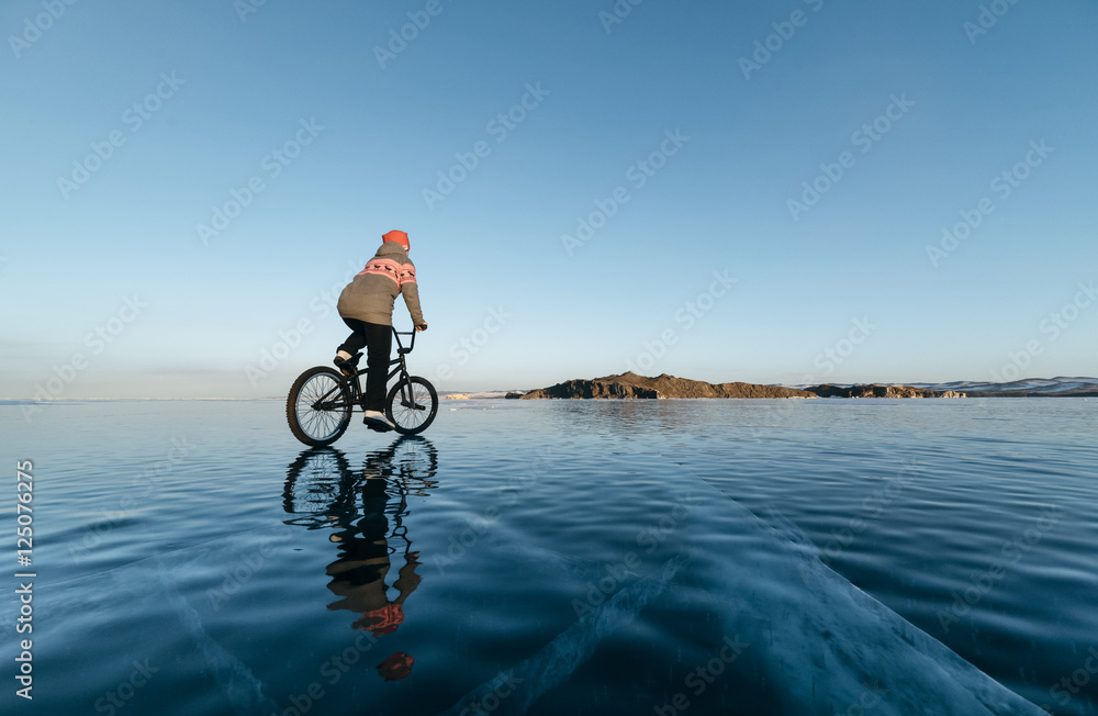 Fototapeta premium Girl on a bmx on ice.