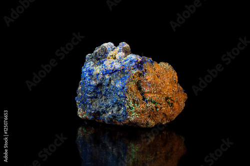 Blue and brown rock with lazurite crystals on black background photo